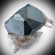 Complex Bixbyite Crystal with Topaz